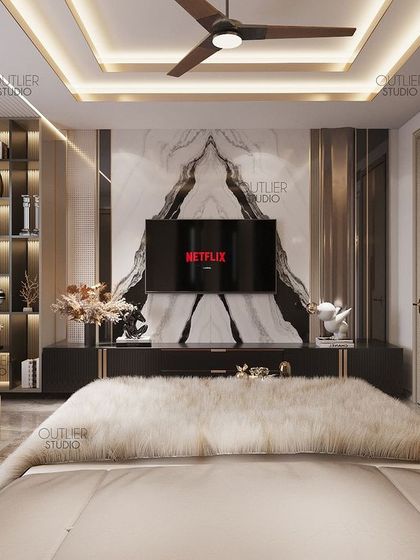 At the end of a long day, we all want calmness and comfort. This bedroom delivers just that, with a plush fur throw, a book-matched marble media wall, and a soft, neutral color scheme.