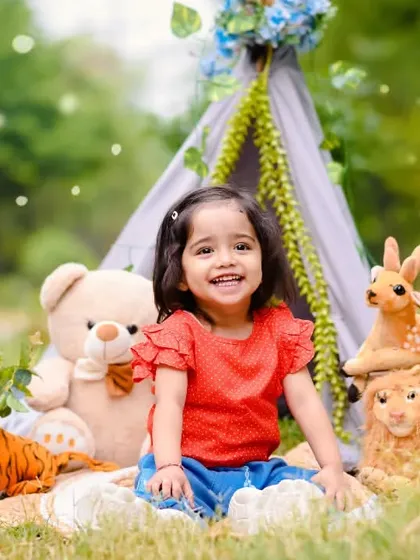Celebrating a second birthday with a smile that lights up the whole park. My outdoor milestone sessions use natural light and fun setups like this animal-themed teepee to capture your child's personality.