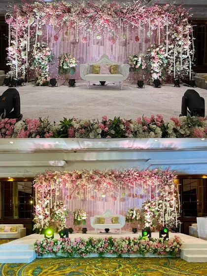 We love creating reception stages that feel like they are straight out of a fairytale. This design features a cascade of pink cherry blossoms, hanging floral strings, and soft lighting to create a deeply romantic and opulent setting for the couple's grand entrance.