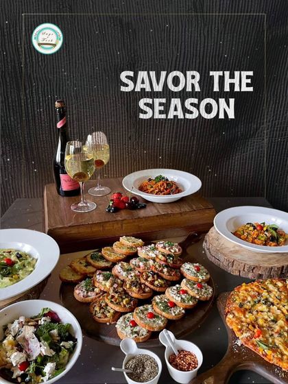 Savor the season with our authentic Italian cuisine platters. This beautiful spread features pasta, pizza, bruschetta, and salad, paired with wine for a perfect gourmet experience at home.