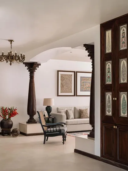A view through the living space, showing how antique pillars and arched openings are used to frame views and define spaces.
