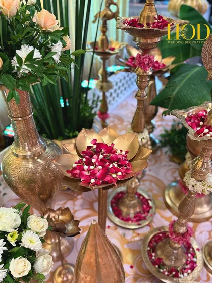It's the small details that bring a design to life. I meticulously arrange traditional elements like these brass urlis and diyas, filled with fresh flower petals, to add a layer of authenticity, culture, and prosperity to the wedding decor.