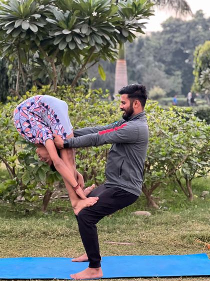 A strong teacher builds strong students. This playful partner pose is as much about having fun as it is about building strength and balance.