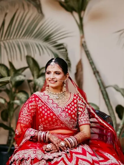 A serene portrait of the bride in a beautiful outdoor setting. The natural light makes her skin look exceptionally radiant.