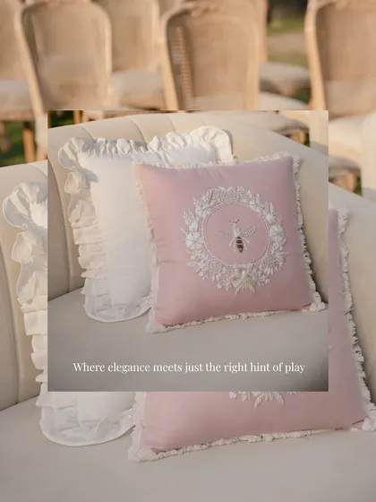 Elegance with a hint of playfulness. These pink cushions, featuring an embroidered bee detail, added a charming and whimsical touch to the seating at one of the wedding events.