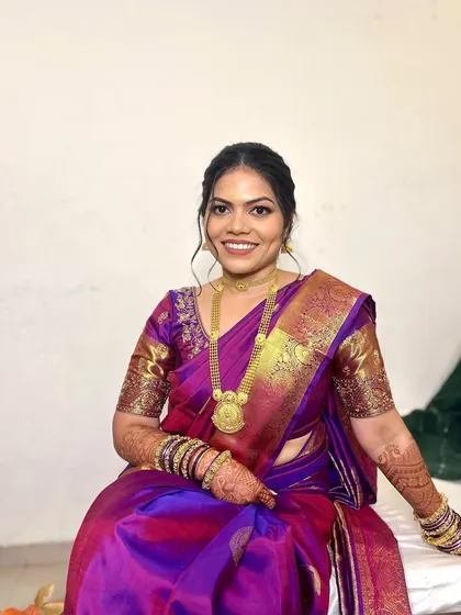 Yana looking absolutely radiant. The complete look, with her gorgeous purple and pink saree, intricate gold jewelry, and my signature glowing makeup, is simply perfect for an engagement ceremony.