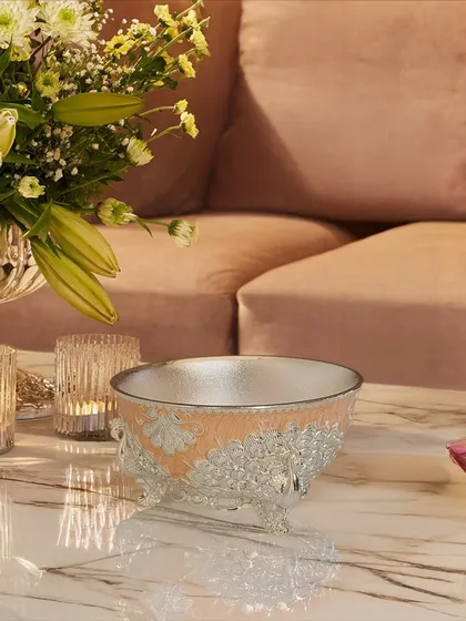 Celebrate the season with something truly special. My enamel bowl with intricate peacock stands, shown here in a soft peach, is perfect for gifting and adding a touch of color to your decor.