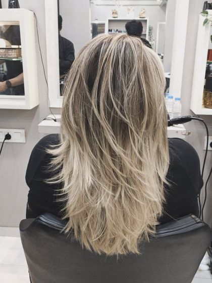 A high-contrast blonde balayage with beautifully textured layers for a modern, edgy look.