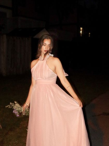 A dreamy, slightly blurred shot of the pink Jardinvue dress at night.