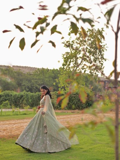 A candid, twirling shot to show the beautiful movement of this sage green lehenga. It's important to choose outfits that are not just beautiful but also comfortable to move in.