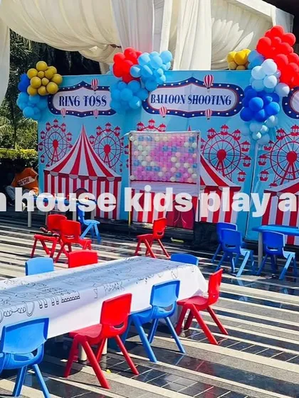 Our red and blue chairs are set up for a carnival-themed party. The bright colors of the furniture match the festive game stalls like ring toss, balloon shooting, and tattoos.