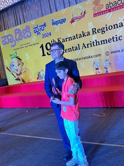 A student receives his trophy at the state awards. These competitions are a great platform for children to test their skills and build resilience.