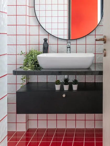 The whimsy of red and white grid tiles turns this bathroom break into a joyful dance of color. This playful retreat, part of a 4-bedroom Mumbai apartment, is every young girl's dream.