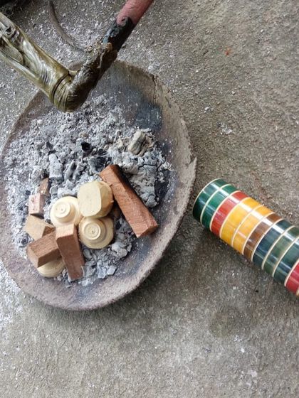 Natural lacquers, derived from organic sources, are prepared for application. Unlike synthetic colors, these traditional dyes create beautiful, varying tonalities in the finished woodcraft.