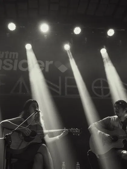 A dramatic black and white shot of our duo performance, with spotlights cutting through the darkness.