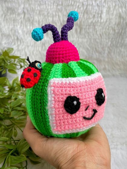 The Cocomelon logo as a plushie! This was a fun and unique request, with the watermelon TV and ladybug friend. The stripes were a challenge, but I love the final result.