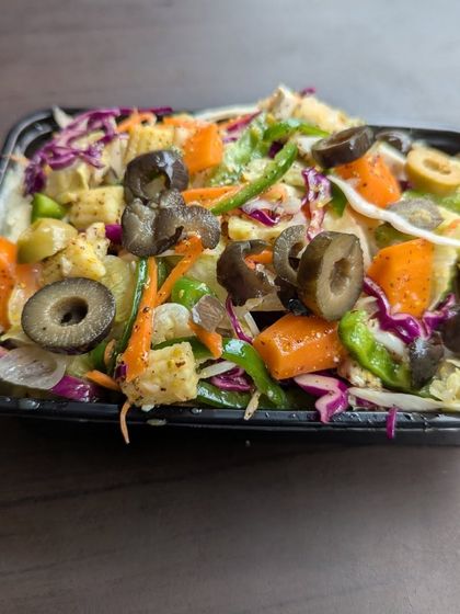 This packed salad is filled with a colorful variety of vegetables like carrots, bell peppers, and red cabbage, along with plenty of olives. It's a convenient way to get your daily dose of vitamins.