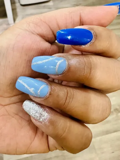 This client got these summery blue nails for a concert. The set includes different shades of blue and a touch of silver glitter.