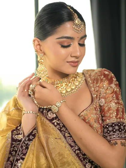This pose captures the soft, romantic feel of the makeup. The peachy tones on the eyes and cheeks give a warm and ethereal glow.