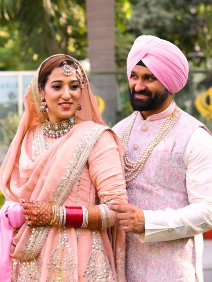 A sweet, candid moment between the couple. The bride's makeup is soft and romantic, perfect for her daytime wedding ceremony.