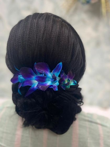 A back view of the beautiful orchid-adorned bun.