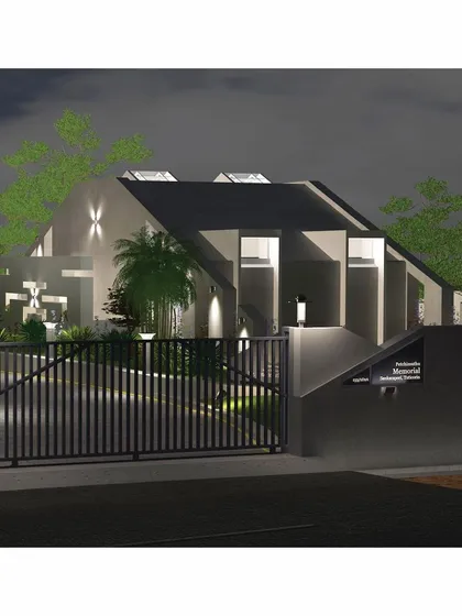 The entrance gate at night, illuminated to ensure a safe and clear point of arrival. The lighting scheme highlights the architectural forms and the surrounding landscape, creating a dramatic and memorable first impression.