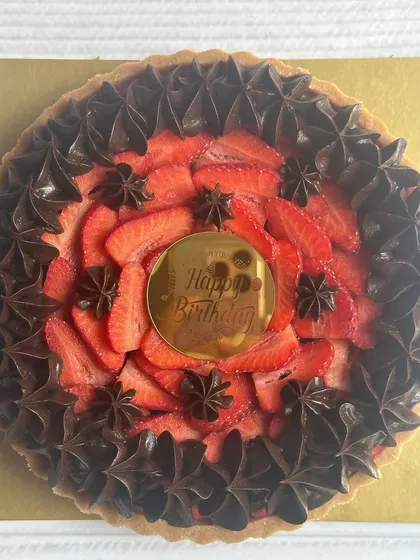 The Choco Strawberry Tart of your dreams! A rich chocolate base is topped with fresh, juicy strawberries and piped chocolate stars, perfect for a birthday treat.