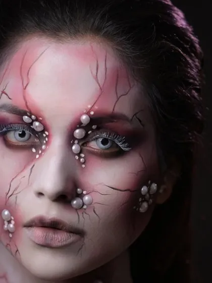 This shot, with dramatic lighting, enhances the creepy and ethereal quality of the character.