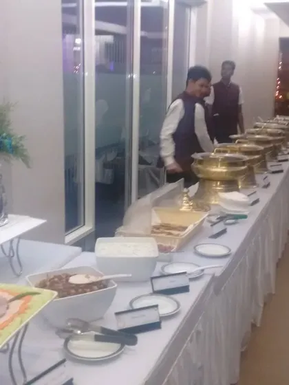 A clean and professional buffet line at an evening corporate function. Our staff is ready to serve guests as they arrive.