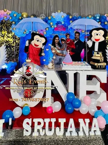We combine decor and entertainment for a truly immersive experience. This first birthday celebration features a massive stage setup with Mickey and Minnie mascots, flanked by professional welcome artists with angel wings, creating a heavenly welcome for the guests.