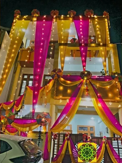 Another example of my home lighting decoration for a wedding. This house features bright pink and yellow drapes with integrated string lights for a stunning night look.