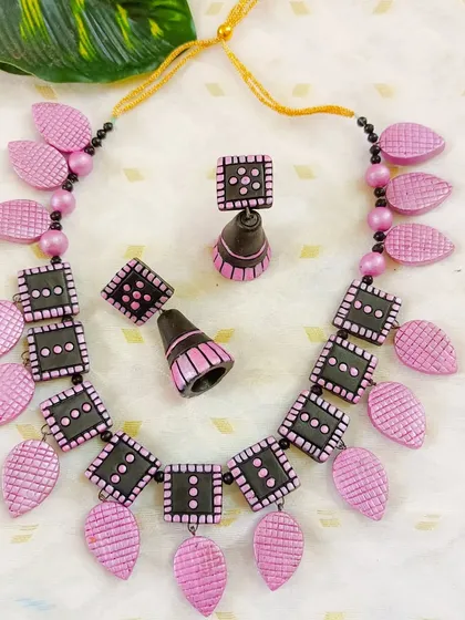 A duplicate image of the soft baby pink and black square and leaf necklace.