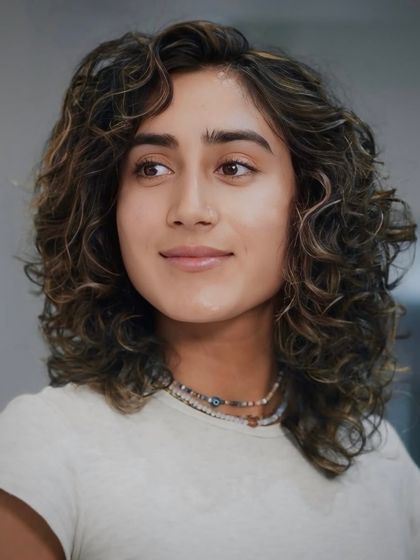 Another angle of this stylish men's curly haircut, demonstrating our expertise in working with all hair textures.