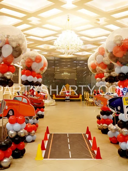 We pay attention to every detail to create a fully immersive world for your child. This car-themed party features a custom-printed roadway aisle, traffic cone details, and themed balloon pillars that guide guests right into the action.