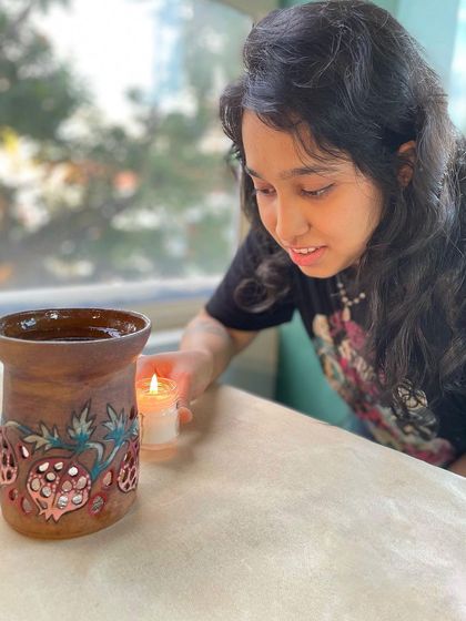 This is one of my professional course students, lighting a candle in a beautiful luminary she created. Her journey is a great example of the growth that happens in our immersive courses.