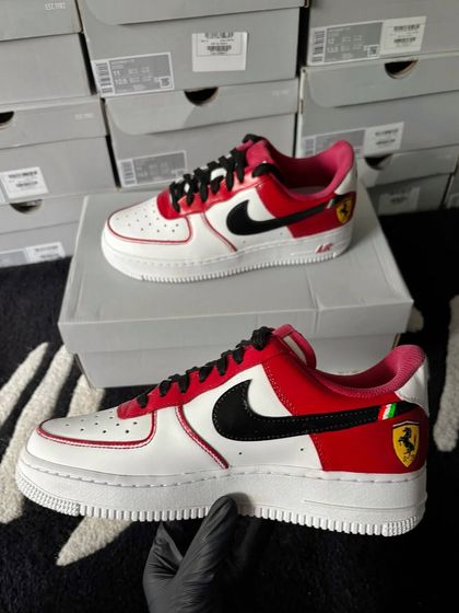 A bold custom Nike Air Force 1 in Ferrari's signature red, featuring the iconic prancing horse logo.