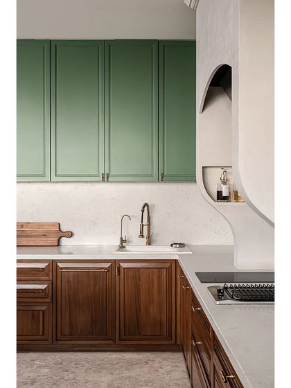 The sculptural plasterwork of the chimney hood and the built-in niche for oils and spices add a custom, artisanal touch to this beautiful and functional kitchen.