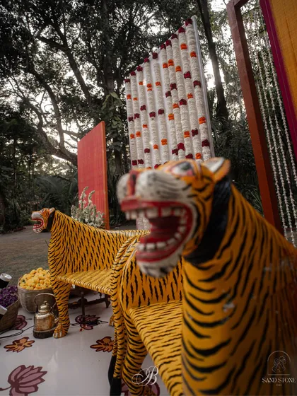 A dramatic shot of the iconic tiger chairs that were a favorite of the bride. Designing the stage around such personal items makes the decor truly one of a kind.