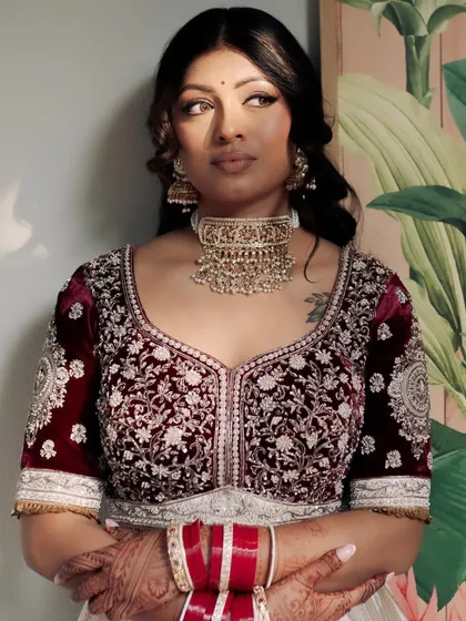 Elegance personified. For Kavi, we chose a classic look with beautifully defined eyes and soft contouring to complement her regal velvet lehenga, letting her natural grace be the focus.