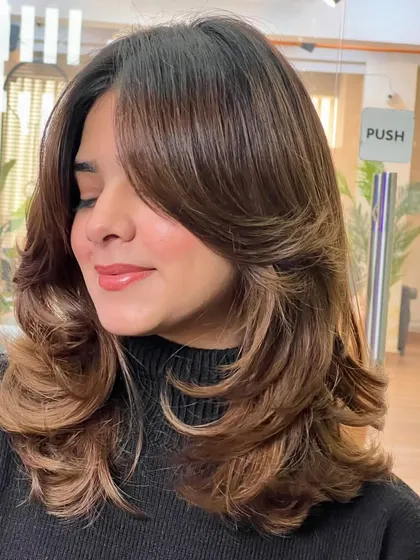 Another angle of this beautiful layered cut and color. The seamless blend of brown tones creates a natural, sun-kissed look that is low maintenance and grows out gracefully.