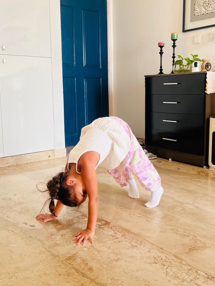 The downward dog pose is a staple in our warm-ups, helping to stretch the entire body and prepare it for dance.