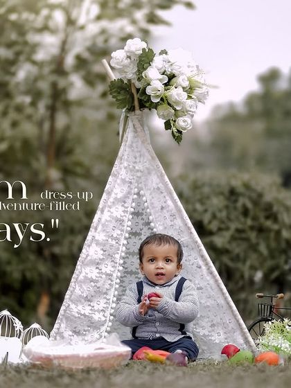 From dress-up days to adventure-filled plays. A toddler enjoys a snack in his teepee during an outdoor session.