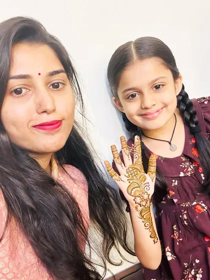 Another sweet picture with Maitreyee, showing off her simple and pretty mehendi design.
