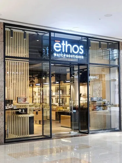 The striking facade of the Ethos Watch Boutiques in Guwahati. We used a combination of glass, blackened steel, and vertical wood slats to create a modern and inviting entrance that reflects the premium nature of the brands within.