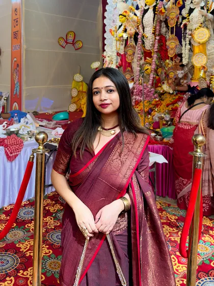 For me, festive dressing is all about embracing our traditions. Here I am, soaking in the Durga Puja vibes in a classic maroon cotton Benarasi saree, showing how traditional wear can be both elegant and powerful.