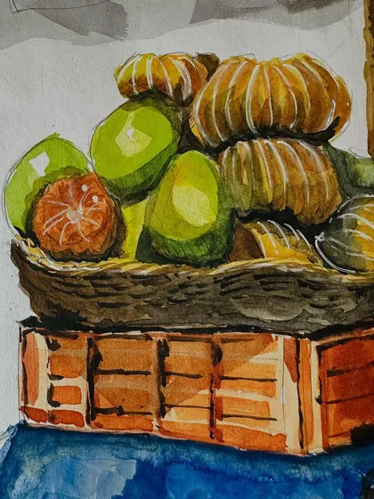 A close-up of the watercolour painting of the fruit basket. I used wet-on-wet techniques to create the soft textures and bright colours of the oranges.