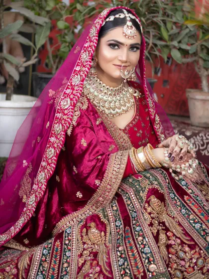 This bride is wearing a deep magenta velvet lehenga. I created a soft, glowing makeup look to complement the richness of the fabric and the heavy jewelry.