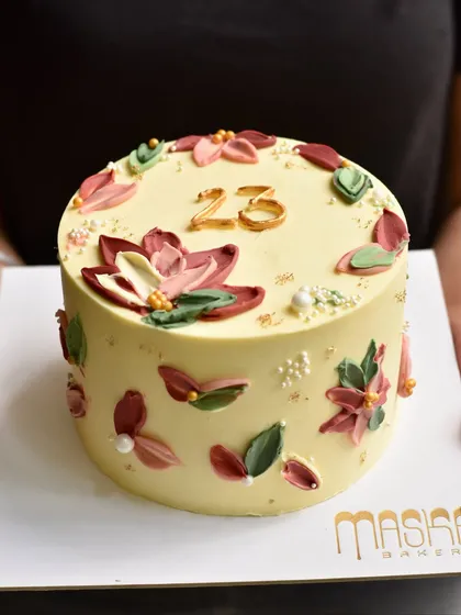 We love being part of your special moments with our custom celebration cakes. This one, with its delicate buttercream flowers, was made for a 23rd birthday. We focus on delicious flavours and natural decorations, never fondant.