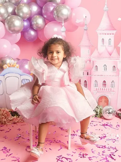 A princess takes her throne. A confident and cute pose from this little girl in her pink castle.