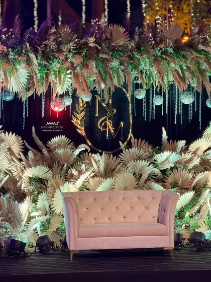 The rustic-chic Sangeet stage illuminated at night, with disco balls catching the light and creating a magical effect.